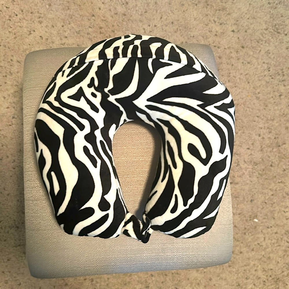Zebra striped neck pillow to take on the airplane with you. Used once.